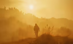 person in the distance walking alone with the sun setting