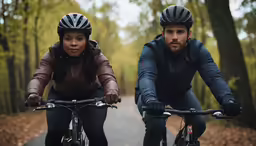 man and woman riding bikes together on an autumn day