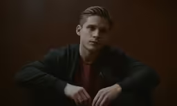 young man with dark hair posing for a picture