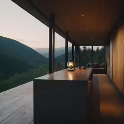 an empty table with some lights on in front of a view