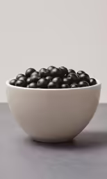 a bowl of berries on a counter