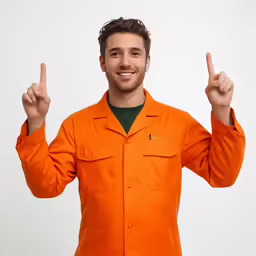a man wearing an orange jacket has two thumbs up