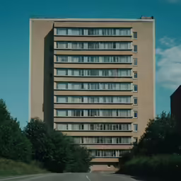 there is a tall building with large windows