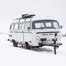 an old fashioned van that is in the snow