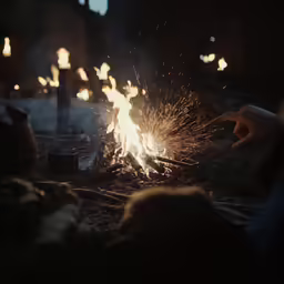 a person reaching out for some food with sparklers