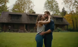 a man and woman standing in front of a building