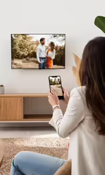 a person in jeans is taking a picture on their phone