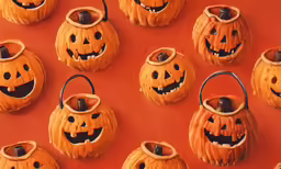 pumpkins with faces made from clay in a pattern