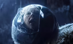 a young child wearing a plastic head and a clear coat