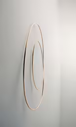 a wall mounted sculpture of circles against the wall