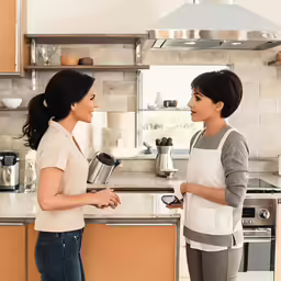two woman talking in the kitchen
