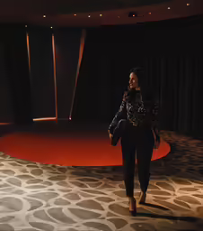 woman on the runway walking away from camera