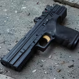 the black handgun is on the ground