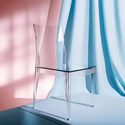 the clear plastic chair is next to the pink wall