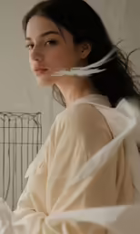 an asian woman with white feather on her hair