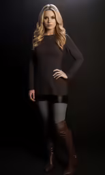 a woman posing for a photo wearing boots and tight clothes