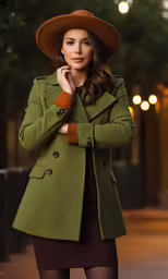 a woman in a long green coat and hat