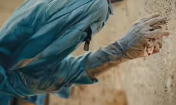 a man holding his hands up on a rock