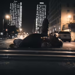 two people are lying on the sidewalk near the street