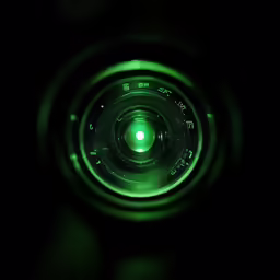 a camera lens that is glowing green