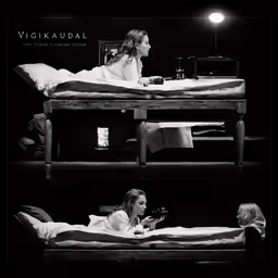 two people are sitting in small beds with their hands near one another