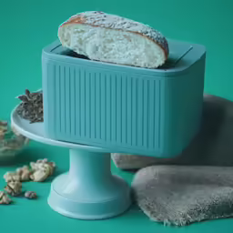 a pastry sitting on top of a plate and next to a pile of peanuts