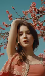 the woman is posing for the picture next to a tree