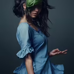 the girl with a green leaf on her head