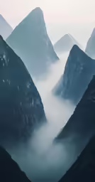 a mountain range covered in thick, fog