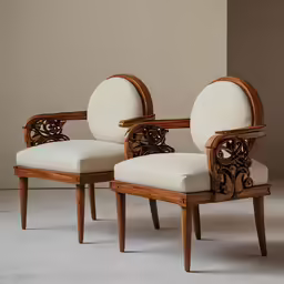 a couple of chairs sitting next to each other on top of a white floor