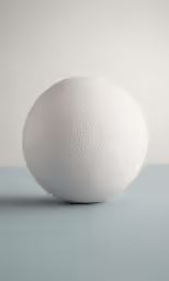 a sphere shaped object sits on the ground