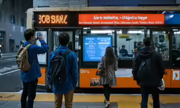 people standing on the sidewalk next to a bus