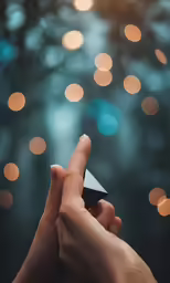 someone holding onto the top of an origami object