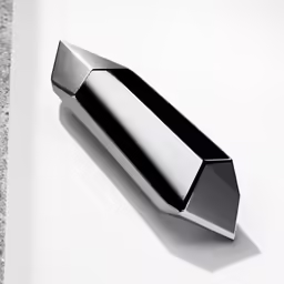 a white surface with a silver object on it