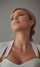 a beautiful woman with a white shirt and gold necklace