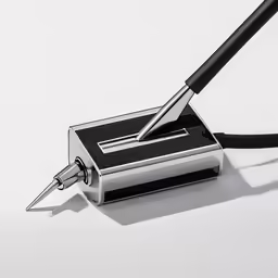 an open metal fountain with a pen attached