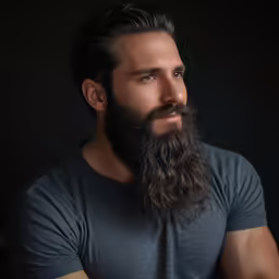 a man with a beard and a grey shirt is posing