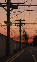 street under a sunset with many electrical wires