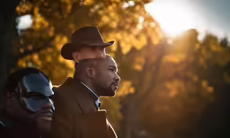 two men in hats and suits are seen