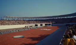 a stadium full of people with one person on the red floor