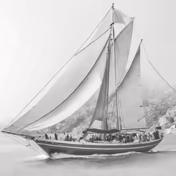the large sail boat is traveling on the water