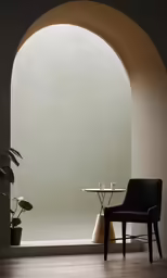 a chair and table in an arched room