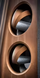 a set of three speakers with a speaker wire connected