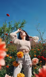 the woman is wearing cropped white pants and a sweater