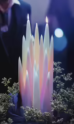 a candle that is sitting on top of some grass