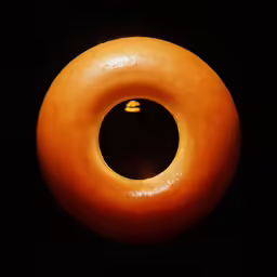 an orange colored object with only one eye visible