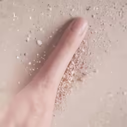a close - up of a finger and grains
