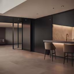 a kitchen with chairs next to the wall
