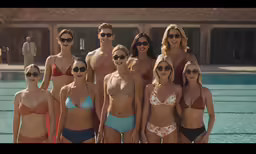 several women standing in swim suits near a pool