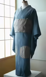 a chinese ancient - era garment is displayed on a pedestal